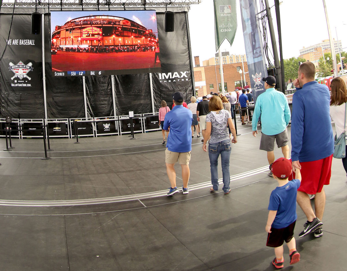people looking at a LED scoreboard
