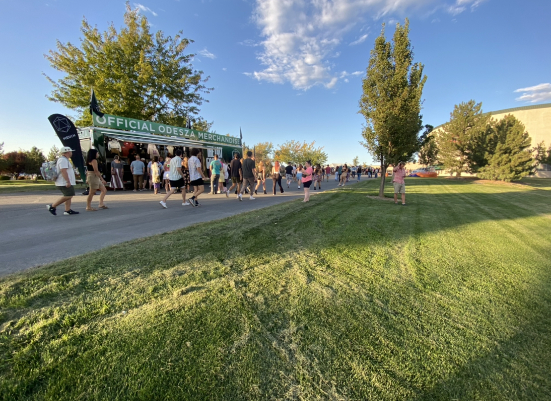 People gathered in front of the ODESZA official mobile merchandise trailer